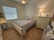 Guest bedroom features natural light, hardwood floors, and a nautical theme creating a tranquil space at 2622 Clarinet Dr, Orlando, FL 32837