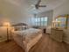 Bright bedroom with hardwood floors, ceiling fan, shutters, and floral bedding for a cozy retreat at 2622 Clarinet Dr, Orlando, FL 32837
