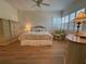 Comfortable bedroom featuring a floral chair, shuttered window, and hardwood floors, creating a cozy ambiance at 2622 Clarinet Dr, Orlando, FL 32837