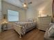 Guest bedroom features natural light, hardwood floors, and nautical bedding creating a tranquil space at 2622 Clarinet Dr, Orlando, FL 32837