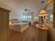 Cozy bedroom with a ceiling fan, wood floors, large windows with plantation shutters, and neutral decor at 2622 Clarinet Dr, Orlando, FL 32837
