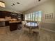 Sunlit eat-in kitchen featuring dark wood cabinets, stainless steel appliances, and a breakfast nook with plantation shutters at 2622 Clarinet Dr, Orlando, FL 32837