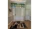 Bright entryway featuring a stylish rug, white door with sidelights, and tropical-themed valance at 2622 Clarinet Dr, Orlando, FL 32837