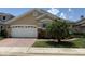 Inviting single-Gathering home with a two-car garage, brick-paved driveway, and manicured lawn at 2622 Clarinet Dr, Orlando, FL 32837