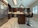 The large kitchen is equipped with a stainless steel refrigerator, dark cabinets, and a center island with bar seating at 2622 Clarinet Dr, Orlando, FL 32837