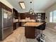 A well-appointed kitchen with dark cabinets, stainless steel appliances, and a center island with a seating area at 2622 Clarinet Dr, Orlando, FL 32837