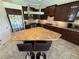 A modern kitchen with dark cabinets, granite countertops, and a unique island layout with bar stools at 2622 Clarinet Dr, Orlando, FL 32837