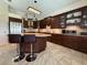 A spacious kitchen features dark wood cabinets, stainless appliances, granite countertops, and a breakfast bar at 2622 Clarinet Dr, Orlando, FL 32837