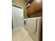 Laundry room featuring a Bosch washer and dryer, tiled flooring and wood cabinets at 2622 Clarinet Dr, Orlando, FL 32837