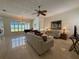 Bright living room with tile floors, piano, and large windows overlooking the pool at 2622 Clarinet Dr, Orlando, FL 32837
