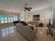 Open living room with tile flooring, piano, and large windows for natural light at 2622 Clarinet Dr, Orlando, FL 32837