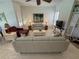 Spacious living room with tile floors, multiple seating areas, and a ceiling fan at 2622 Clarinet Dr, Orlando, FL 32837