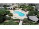 Aerial view of a uniquely shaped pool, palm trees, lounge chairs, a gazebo and lush landscaping at 2622 Clarinet Dr, Orlando, FL 32837