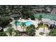 Aerial view of a community pool, tennis courts, palm trees and well maintained landscaping at 2622 Clarinet Dr, Orlando, FL 32837