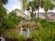 Scenic community water feature surrounded by lush tropical landscaping and views of well-maintained homes at 2622 Clarinet Dr, Orlando, FL 32837