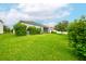 Spacious backyard with well-maintained lawn, landscaping, and mature trees at 3142 Dark Sky Dr, Harmony, FL 34773