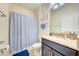 Well-lit bathroom with a shower-tub combo, granite countertop, and a blue bathmat at 3142 Dark Sky Dr, Harmony, FL 34773