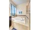 Bright bathroom with a luxurious soaking tub and stylish tile surround at 3142 Dark Sky Dr, Harmony, FL 34773