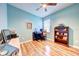Bedroom featuring a desk, chair, bookshelf, and wood floors at 3142 Dark Sky Dr, Harmony, FL 34773