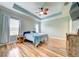 Cozy bedroom with a tray ceiling, fan and natural light at 3142 Dark Sky Dr, Harmony, FL 34773