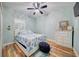 Serene bedroom with a comfortable bed, ceiling fan, and wood-look flooring, offering a relaxing atmosphere at 3142 Dark Sky Dr, Harmony, FL 34773