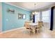 Bright dining room featuring tile floors, light blue walls, large window, and a modern chandelier at 3142 Dark Sky Dr, Harmony, FL 34773