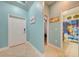 Inviting entryway featuring tile flooring, access to bathroom, and views of the hallway, enhancing the home's layout at 3142 Dark Sky Dr, Harmony, FL 34773
