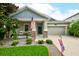 Charming single-Gathering home featuring a well-manicured lawn, stone accents, and a two-car garage at 3142 Dark Sky Dr, Harmony, FL 34773