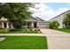 Well-maintained home with a neat front lawn, an American flag, and a spacious driveway leading to a two-car garage at 3142 Dark Sky Dr, Harmony, FL 34773