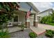 Inviting front porch featuring cozy seating and decorative stone columns, creating a warm and welcoming entrance at 3142 Dark Sky Dr, Harmony, FL 34773