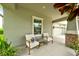 Charming front porch with comfortable seating, offering a cozy spot to relax and enjoy the neighborhood ambiance at 3142 Dark Sky Dr, Harmony, FL 34773