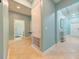 Hallway with light blue walls, neutral tile flooring, and access to other rooms at 3142 Dark Sky Dr, Harmony, FL 34773