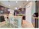 A spacious kitchen features stainless steel appliances, an island with granite countertops, and dark wood cabinets at 3142 Dark Sky Dr, Harmony, FL 34773