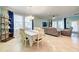 Open-concept living and dining area featuring a ceiling fan and large windows at 3142 Dark Sky Dr, Harmony, FL 34773