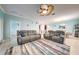 Spacious living room featuring two reclining couches, a ceiling fan, and an open floor plan at 3142 Dark Sky Dr, Harmony, FL 34773