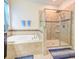 Elegant bathroom features granite countertops, a soaking tub, and a glass enclosed shower at 3142 Dark Sky Dr, Harmony, FL 34773