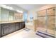 Main bathroom with granite countertops, dual sinks, soaking tub, and glass enclosed shower at 3142 Dark Sky Dr, Harmony, FL 34773