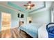 The Main bedroom features wood floors, a ceiling fan, and an ensuite bathroom with a glass shower at 3142 Dark Sky Dr, Harmony, FL 34773