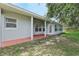 Backyard view highlighting a covered patio, lush grass, and well-maintained landscaping at 3326 Sassaquin Ct, Orlando, FL 32818
