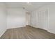 Spacious bedroom with wood floors and a double door closet offers a clean and modern aesthetic at 3326 Sassaquin Ct, Orlando, FL 32818