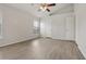 Bright bedroom with wood-look floors, ceiling fan, and closet space, offering comfort and style at 3326 Sassaquin Ct, Orlando, FL 32818