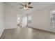 Bright bedroom featuring wood-look flooring, a ceiling fan, and an ensuite bathroom entrance at 3326 Sassaquin Ct, Orlando, FL 32818