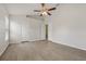 Bedroom featuring wood-look flooring, ceiling fan, closet, and ensuite bathroom access at 3326 Sassaquin Ct, Orlando, FL 32818