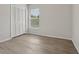 Bedroom featuring wood-look flooring, natural light, and closet, offering a serene retreat at 3326 Sassaquin Ct, Orlando, FL 32818