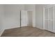 Bedroom with wood-look floors, closet, and ensuite bathroom access, creating a private space at 3326 Sassaquin Ct, Orlando, FL 32818