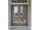 Close-up of the home's double front doors with glass inserts, offering a welcoming entrance at 3326 Sassaquin Ct, Orlando, FL 32818