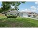 Lovely single-story home featuring lush green lawn, mature trees, and an attached two-car garage at 3326 Sassaquin Ct, Orlando, FL 32818