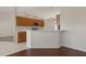 Kitchen with wood cabinetry, stainless microwave, a breakfast bar, and tile flooring at 3326 Sassaquin Ct, Orlando, FL 32818