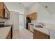 Bright kitchen has stainless appliances, wood cabinets, white countertops, and tile flooring at 3326 Sassaquin Ct, Orlando, FL 32818