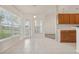 Eat-in kitchen has nice natural light and features tile floors, access to the backyard, and crisp white walls at 3326 Sassaquin Ct, Orlando, FL 32818